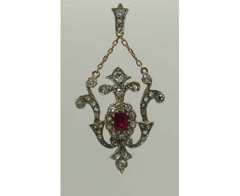 A ruby and diamond pendant set in yellow and white metal, the diamonds are a mix of rose and old cuts to an estimated total o