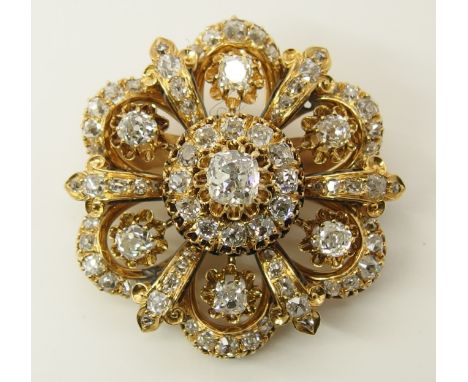 A substantial old cut diamond brooch the central old cushion cut is estimated approx 1ct, with diamond set fleur de lys strap