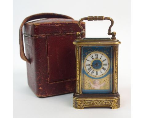 A brass boudoir carriage clock with four printed and overpainted porcelain panels, depicting cherubs, together with a red lea