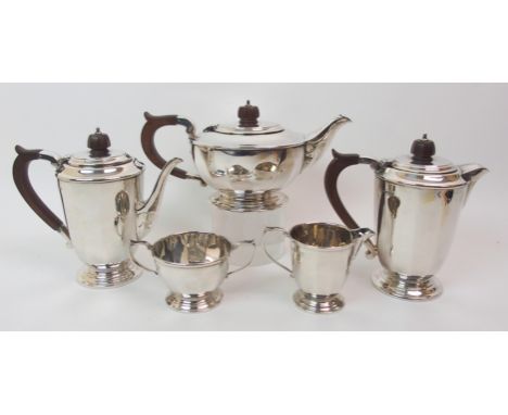 A five piece silver tea service by Mappin and Webb, Sheffield 1938, of tapering cylindrical form with faceted body on stepped