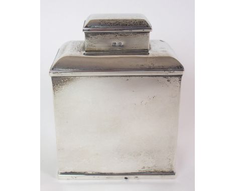 A silver tea caddy unclear maker's marks, Birmingham 1928, of plain rectangular shape with curving shoulders, 10cm high, 6oz