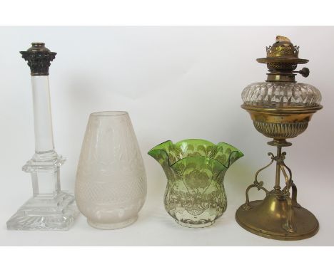 A lead crystal oil lamp base with a brass acanthus terminal, a cut glass oil lamp with brass stand (unassociated) and two gla