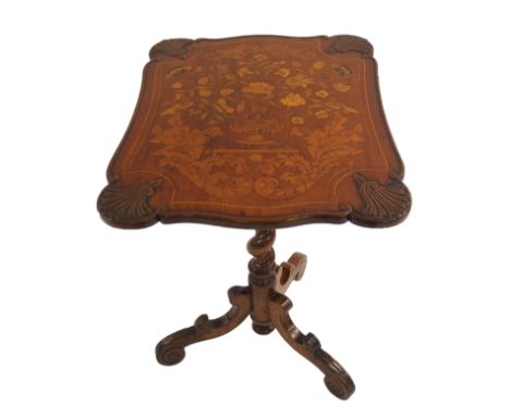 A Dutch marquetry tilt-top tripod table decorated with a vase of flowers on a ledge above acanthus leaf within scallop moulde