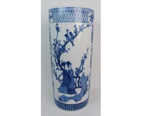 A Chinese blue and white stick stand painted with figures amongst blossoming branches, divided by scrolling foliage and withi