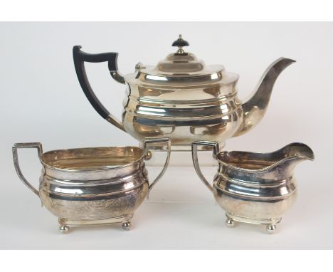 A three piece silver tea service maker's marks EJE, Sheffield 1941, of rounded rectangular shape on four ball feet, 36oz (3)