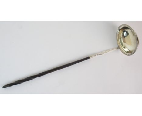 A silver toddy ladle unknown maker, probably London 1804 with oval bowl and barley twist whalebone handle, 33cm long
