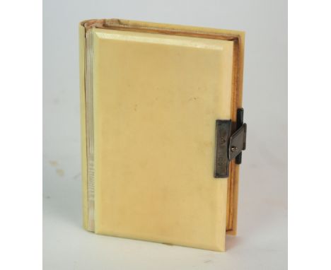 An early 20th Century Book of Common Prayer with ivory covers and silver-mounted clasp, in leather case, ivory brushes, carve