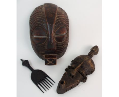A Luba female Kifwebe mask carved with facial scaring, 30.5cm high, Tsonge mask, carved with head finial, 36cm high and a Lul