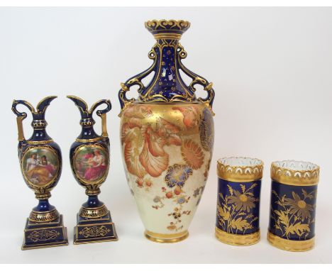 A Royal Crown Derby twin handled vase the flaring neck in cobalt blue with gilt pattern above a tapering body decorated with 