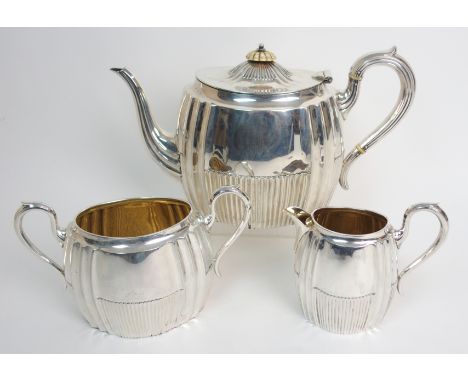 A Victorian three piece silver tea service by William Marshall & Son, Edinburgh 1895, of rounded rectangular form with fluted