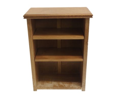 In the style of Robert 'Mouseman' Thompson, an oak small open bookcase the moulded rectangular top above two adjustable shelv