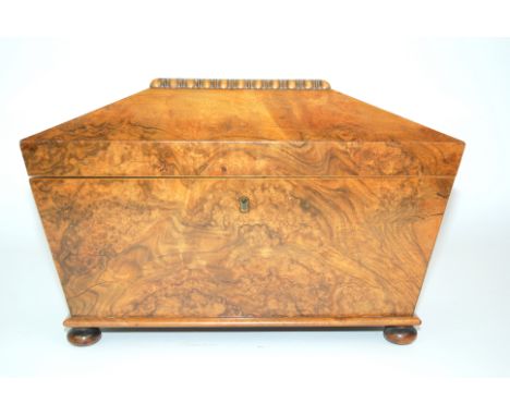 A mid-19th Century mahogany sarcophagus shaped tea caddy with hinged lid and two division interior with mixing bowl on bun fe