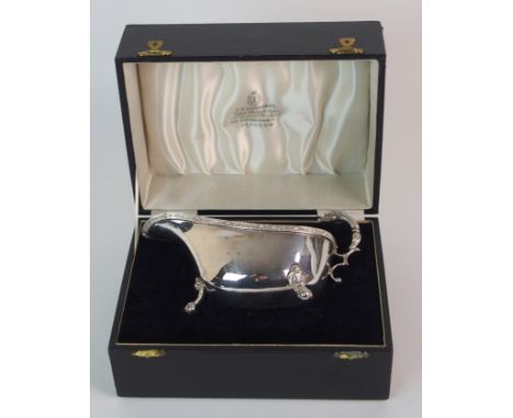 A silver sauceboat by Charles S Green & Company Limited, Birmingham 1937, of classic shape, the rim with Celtic decoration, t