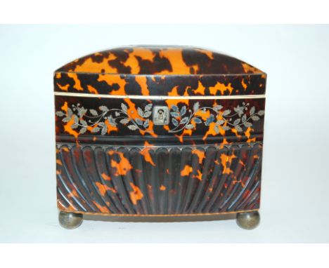 A Regency tortoiseshell bow fronted and white-metal floral inlaid tea caddy on white-metal bun feet, 14cm high x 17.5cm wide 