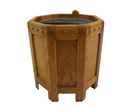 A Robert 'Mouseman' Thompson oak octagonal fire bin the metal liner with swing handle, framed by eight recessed panels beneat