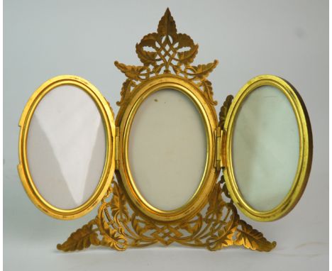 A Victorian gilt-metal oval triptych photograph frame one panel inset with pietra dura plaque, on easel stand, the stand insc