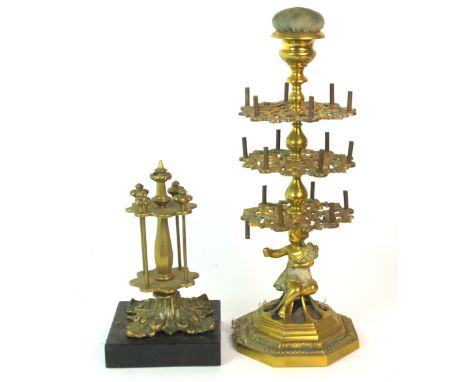 A brass three tier bobbin turner with pin cushion finial, the base cast with figure, 36cm high and another (2)