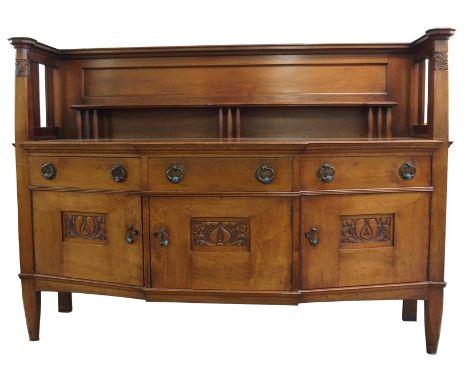 An Arts and Crafts oak sideboard probably by Wylie & Lochhead, Glasgow, the superstructure with an open shelf on tapering sup