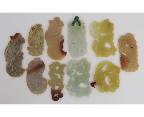 Four Chinese hardstone pedant carvings three foliate scrolls and an axe head, 8cm to 10.5cm and six other carvings (11)