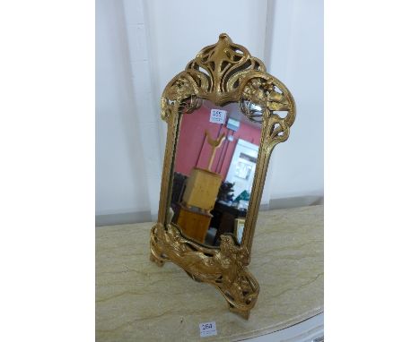 An Art Nouveau style gilt framed toilet mirror