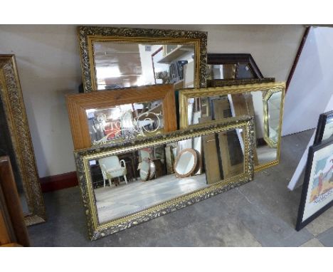 Four gilt framed mirrors, advertising mirror and a mahogany effect overmantel mirror