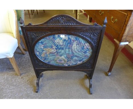 An Edward VII oak and embroidered firescreen