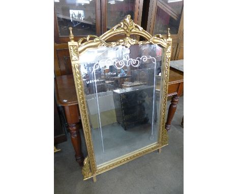 A reproduction French Louis XV style gilt mirror