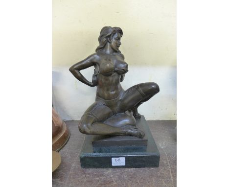 A bronze figure of an erotic female, on black marble base