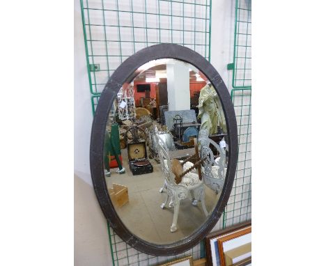 An Arts and Crafts hammered pewter mirror