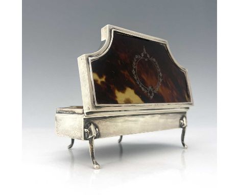 A George V silver and tortoiseshell jewellery or ring box, of rectangular form with dual canted corners, atop four pad feet, 
