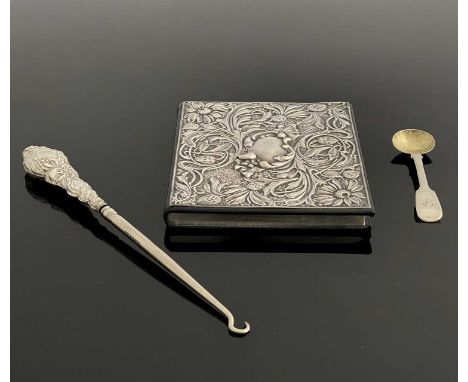 An Elizabeth II silver-mounted leather address book, the repousse cover decorated in the Rococo style with flowerheads and fl