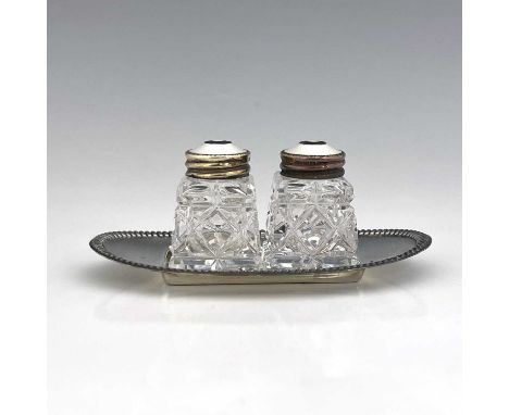 Norway.A twentieth century Norwegian cruet set, comprising a pair of cut glass shakers with sterling silver tops secured with