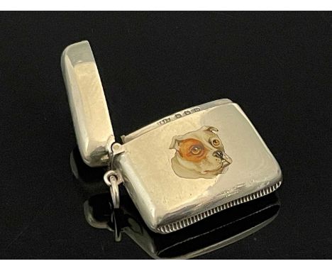 A Victorian silver and enamel vesta case, of rounded and shaped rectangular form, with an applied polychrome enamel plaque of