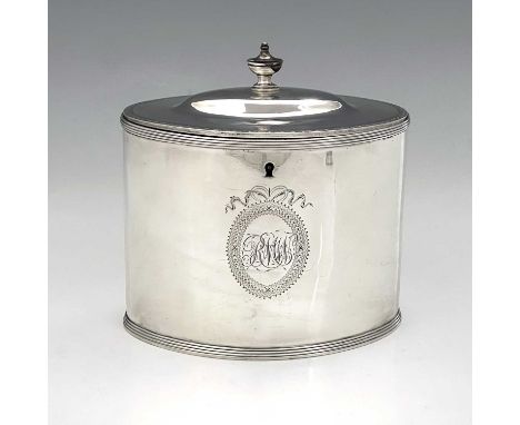 A George III silver neoclassical tea caddy, of drum shape with urn form finial, the exterior with reeded border, and twin opp