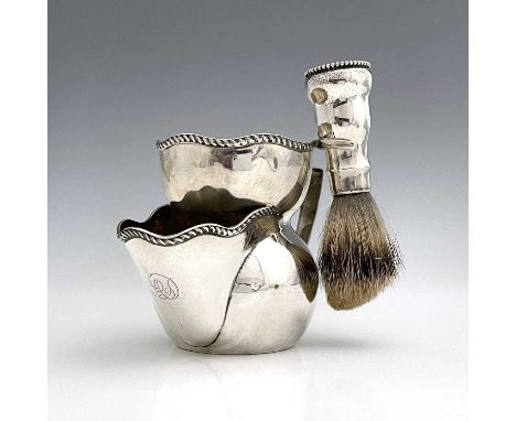 A late nineteenth or early twentieth century silver shaving mug, of waisted cylindrical form, with gadroon edge rim, angular 