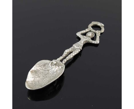 A Victorian cast silver figural spoon, the handle modelled in the form of a harlequin holding a snake ring, the leaf-shaped b