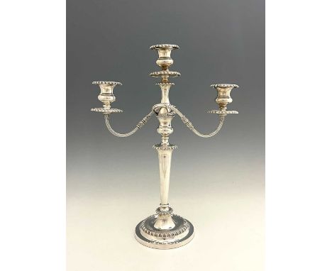 An Edwardian silver three-light candelabrum, modelled in the George III style, with a tapered cylindrical column, atop a spre