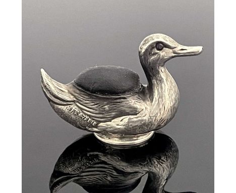 A George V novelty silver pin cushion, modelled in the form of a duck, the body with cushion pad and decorated to simulate fe
