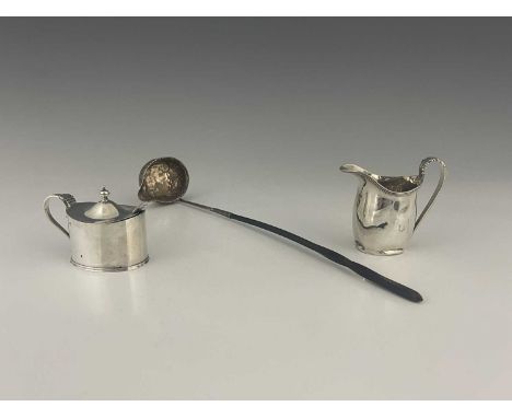 A George VI silver cream jug, of cylindrical form with loop handle and acanthus leaf thumbpiece, sponsor's mark rubbed, Chest