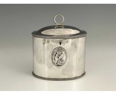 A George III silver tea caddy, of drum form, in the neoclassical style, with bead edge border, the body applied with dual pan