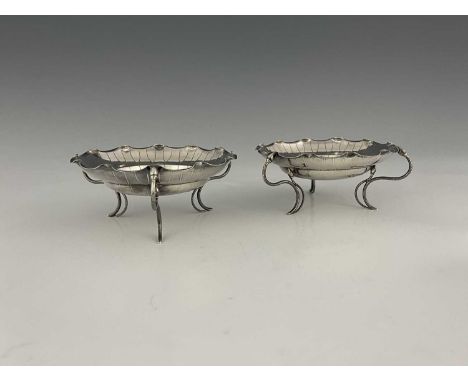 China.A pair of late nineteenth or early twentieth-century Chinese export silver lotus leaf bon-bon dishes, each atop three s