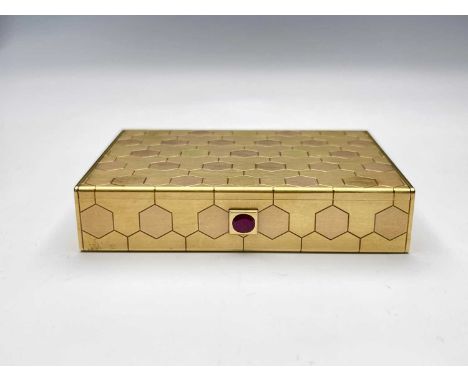 Cartier.An 18ct gold box, of rectangular form, the body decorated with stylised hexagonal tesserae in vari-coloured gold, the