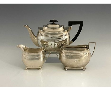 A George V silver three-piece tea set, comprising teapot, two-handled sugar bowl and milk jug, each of navette form with cent