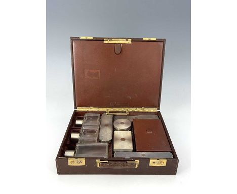 FranceAn early twentieth-century French gentleman's leather travelling vanity case, containing silver and silver-gilt-mounted