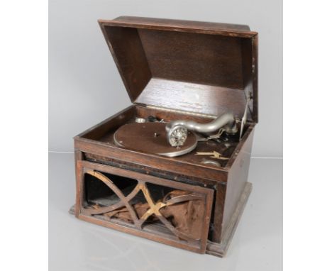 A table grand gramophone, HMV Model 104A, with 5A sound box, in oak case (spring slipping, fret damaged, extra holes in motor