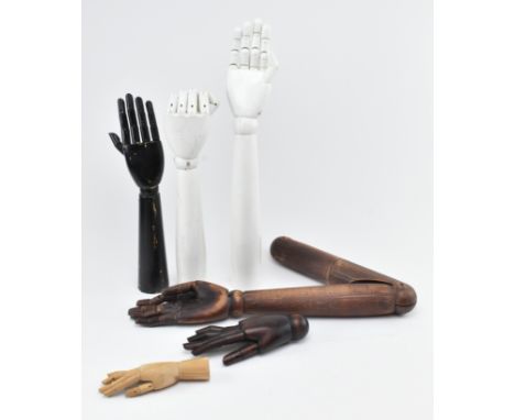 An assortment of vintage 20th century &amp; later painted &amp; carved wood articulated fingers mannequin / shop display hand