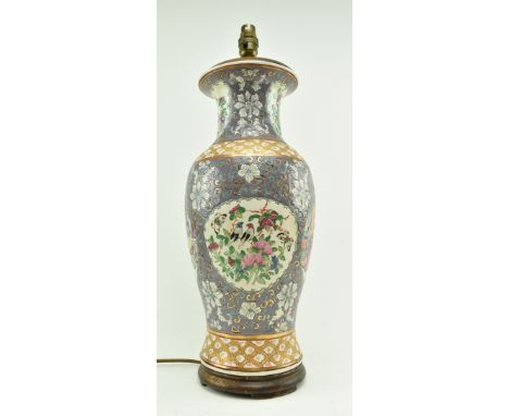 A 20th century Chinese vase converted to lamp base. The baluster shaped vase with flared rim, flowers motif on the neck, pane