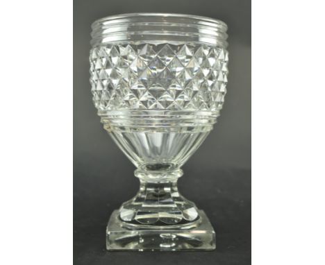 An early - mid 19th century Anglo-Irish cut glass centrepiece vase. The vase with three step cuts to the rim over diamond cut
