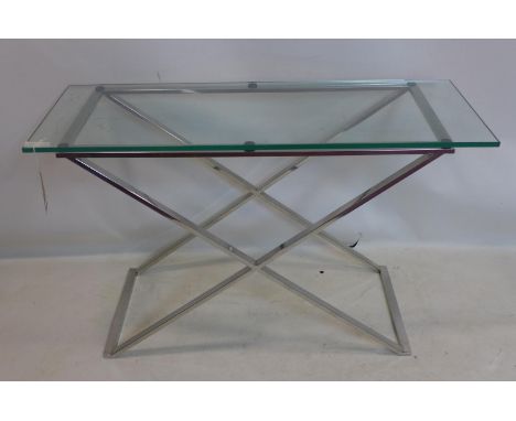 A contemporary console table with glass top raised on chrome X frame base, H.76 W.122 D.46cm 