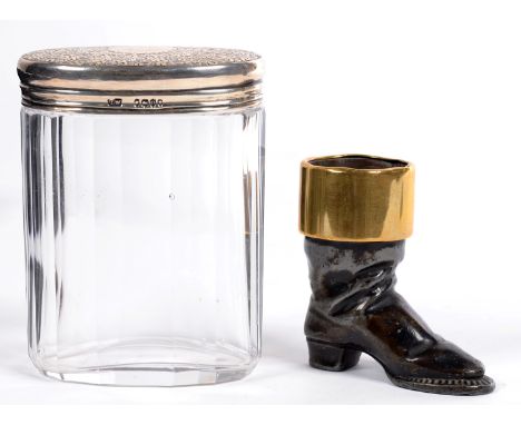 A VICTORIAN BRASS MOUNTED LEAD BOOT NOVELTY MATCH STAND, 6CM H AND A GLASS JAR WITH SILVER COVER FROM A DRESSING CASE 